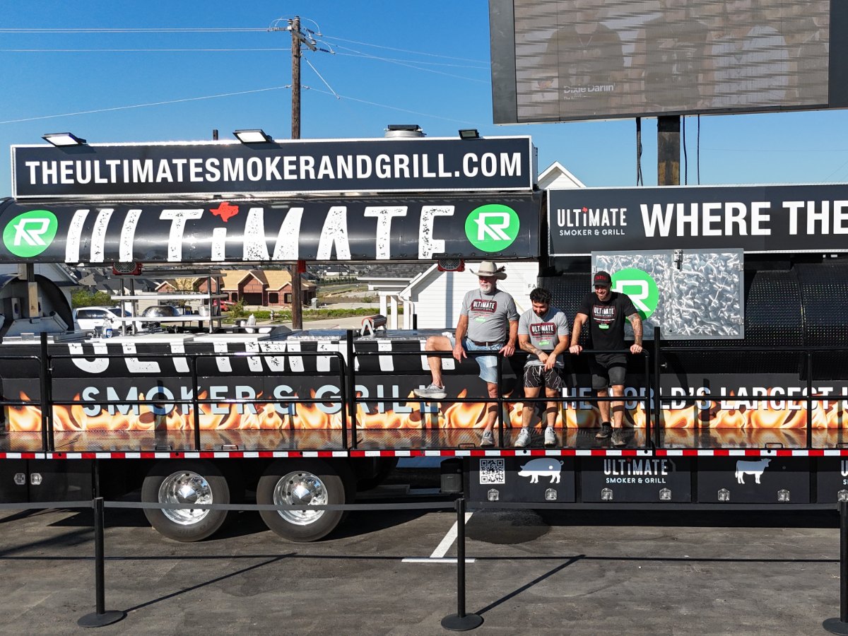 Partner logos on the front of the rig, with guests up on the deck